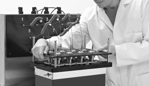 Scientist in a lab coat adjusting a PolyBLOCK lid